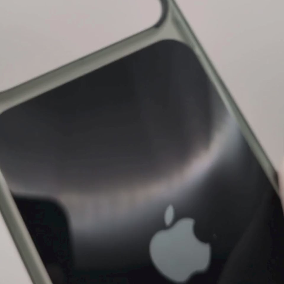 Video black iphone 18 case demo with a silver metallic bumper frame and a silver Apple logo in the center, shown on a plain white background.